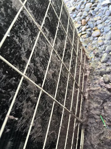 Foundation access grating showing proper HVAC system ventilation and maintenance access for AC repair in Salem Oregon