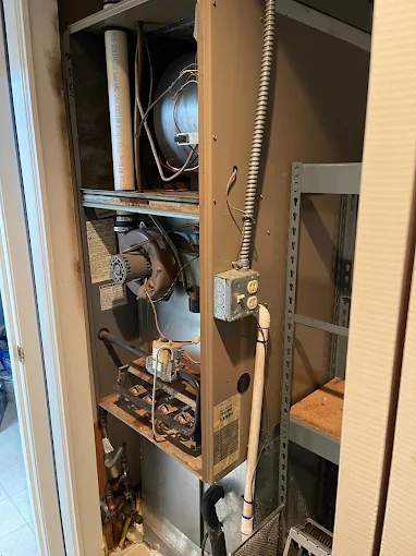 Professional furnace repair technician inspecting heating system in Salem Oregon basement